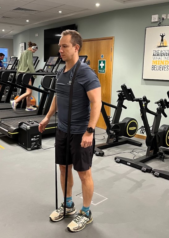 Man performing a resistance band single-leg deadlift