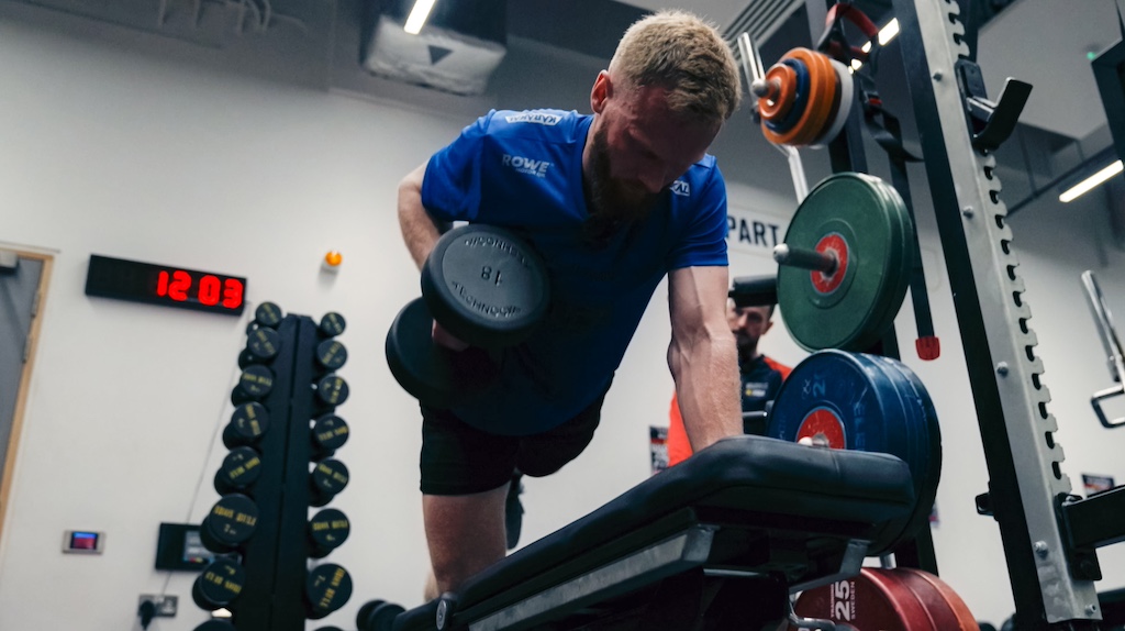 Single-arm dumbbell rows in the gym