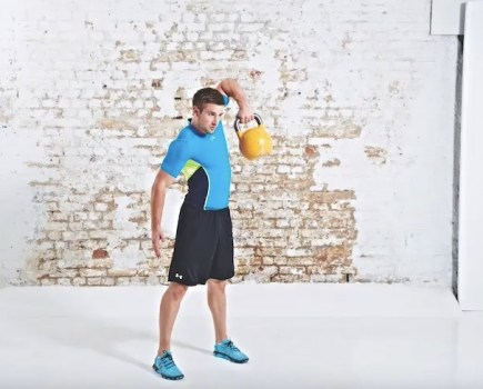 Man performing a kettlebell snatch