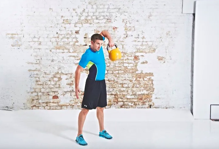 Man performing a kettlebell snatch