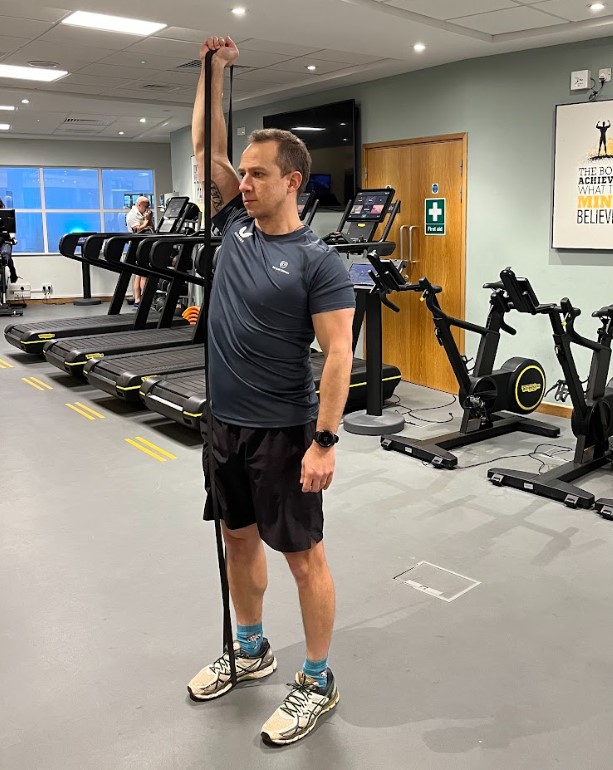 Man performing a resistance band squat press