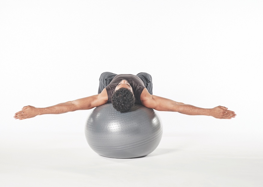 man demonstrating exercise ball crab walk