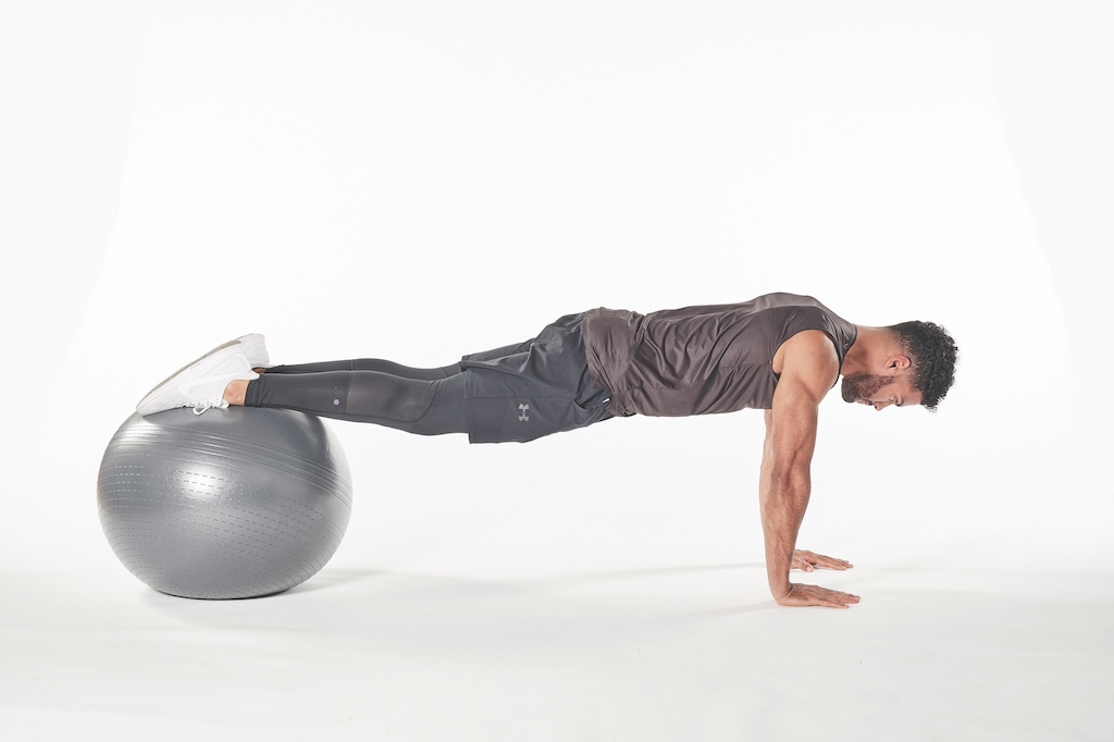 man demonstrating exercise ball jackknife