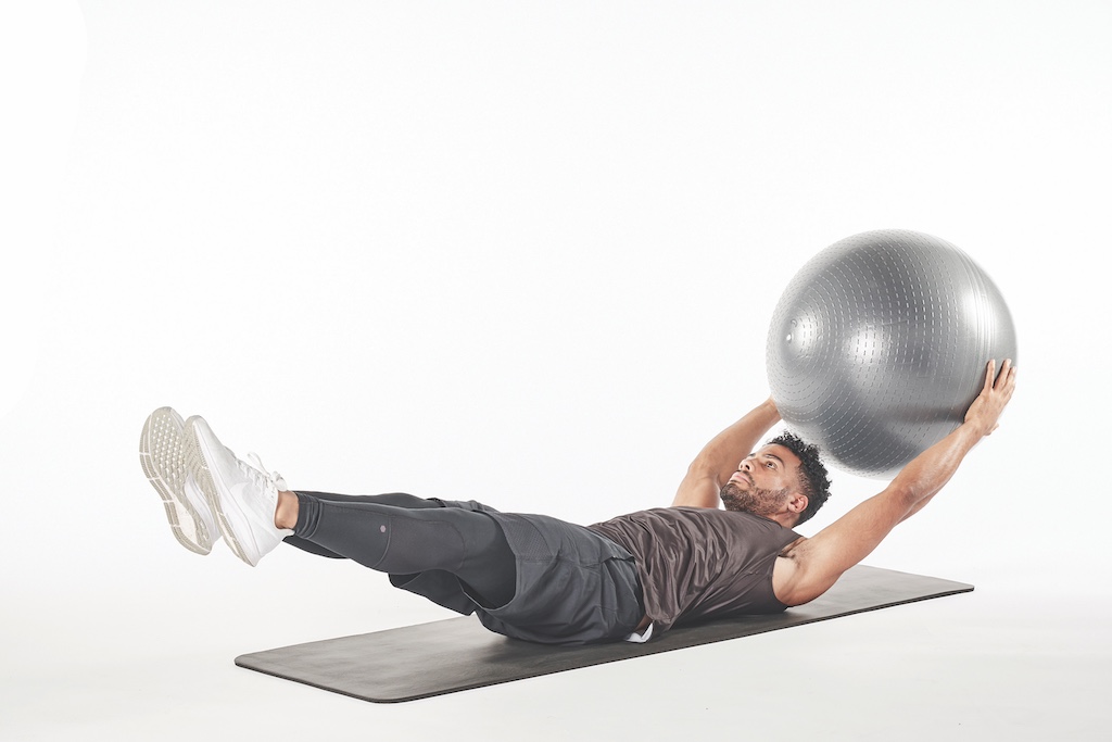 man demonstrating exercise ball pass