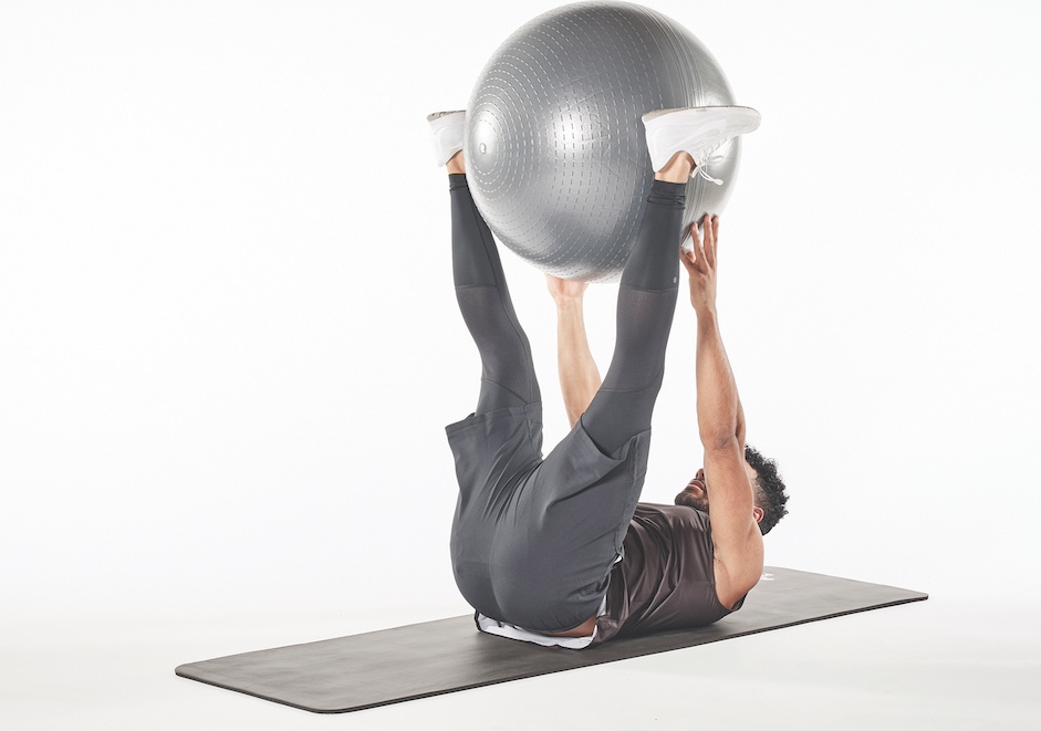 man demonstrating exercise ball pass