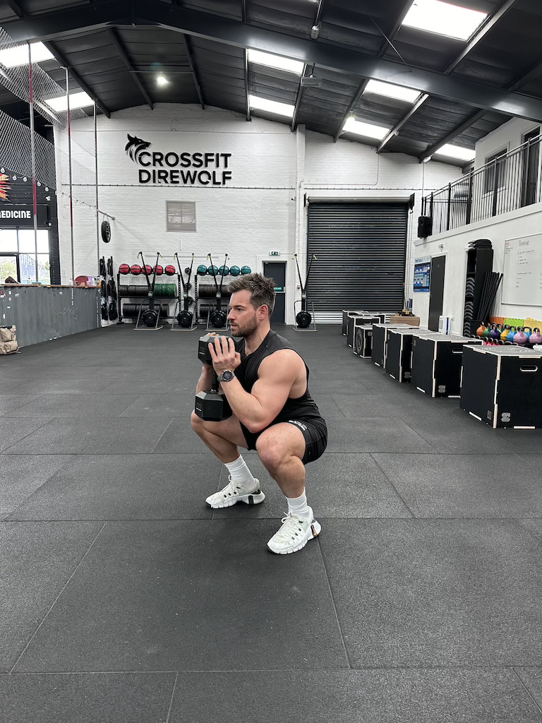 man performing dumbbell goblet squat