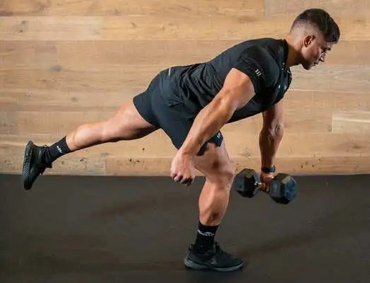 Man performing one-legged dumbbell exercise