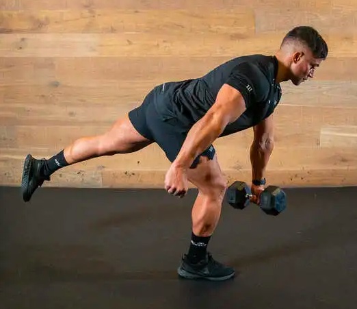 Man performing one-legged dumbbell exercise