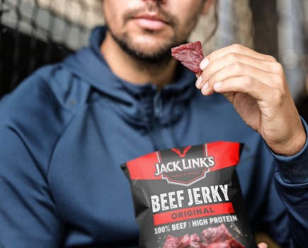 man eating Jack Link's beef jerky from the packet