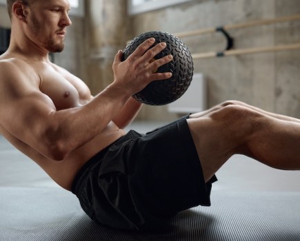 Man performing a medicine ball crunch