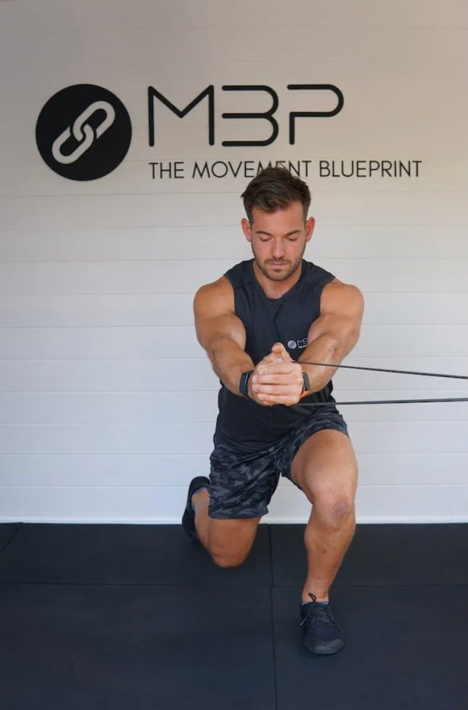 Man performing split squat with band exercise