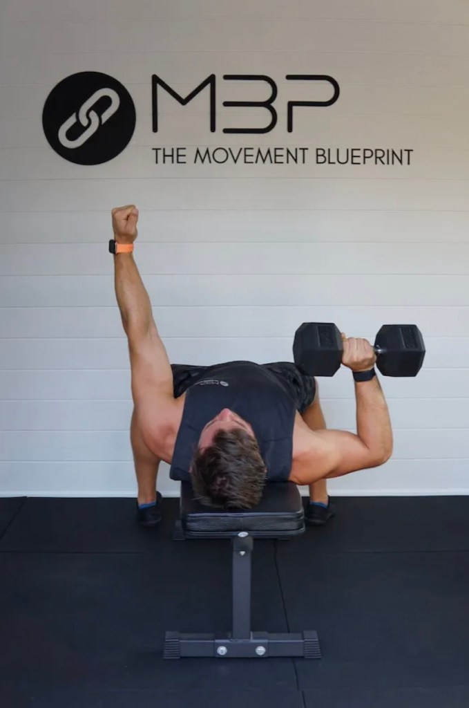 Man performing single-arm bench press