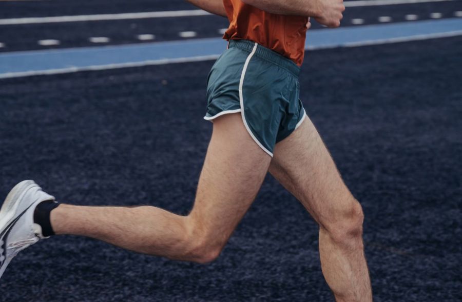 Man running while wearing the Tracksmith Twilight 3-inch split short