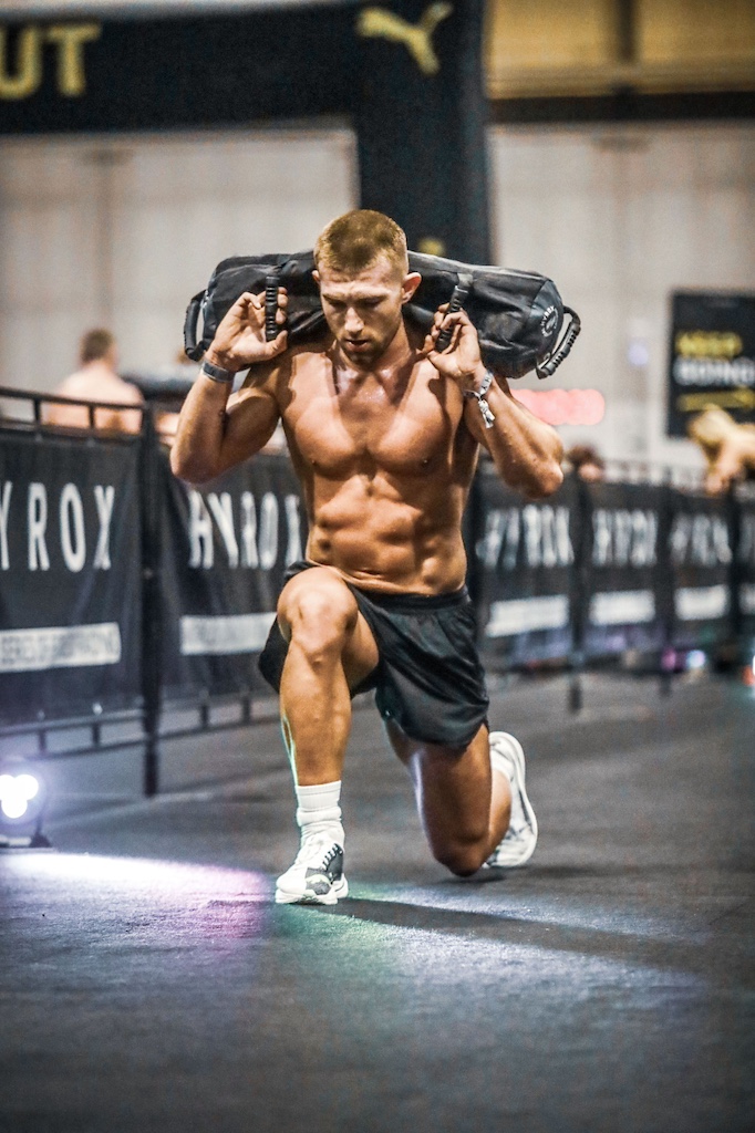 Hyrox athlete Jake Dearden performing a sandbag lunge