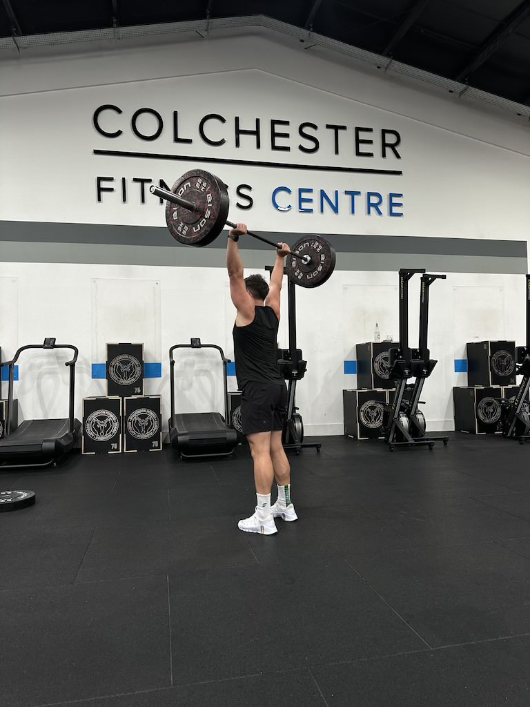 PT Harvey Lawton demonstrating how to do a barbell strict press