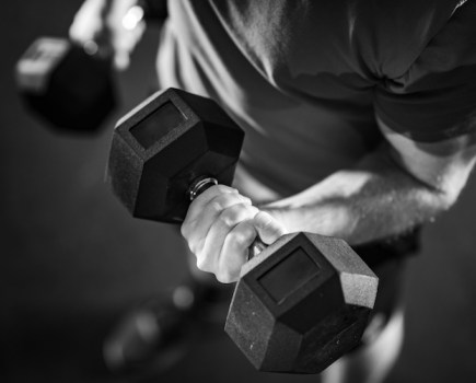 Close-up of a man performing a dumbbell curl