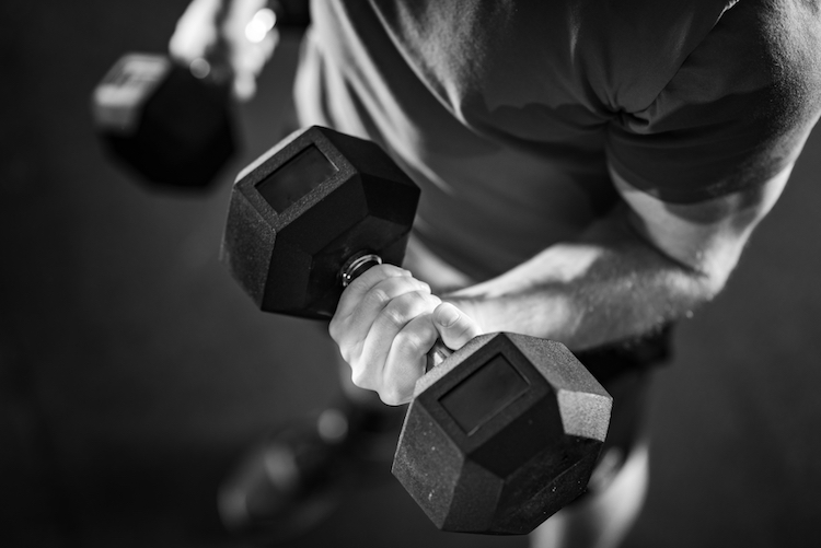 Close-up of a man performing a dumbbell curl