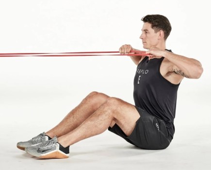 Man performing a seated resistance band exercise