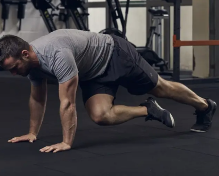 A man in the gym performing bodyweight exercises