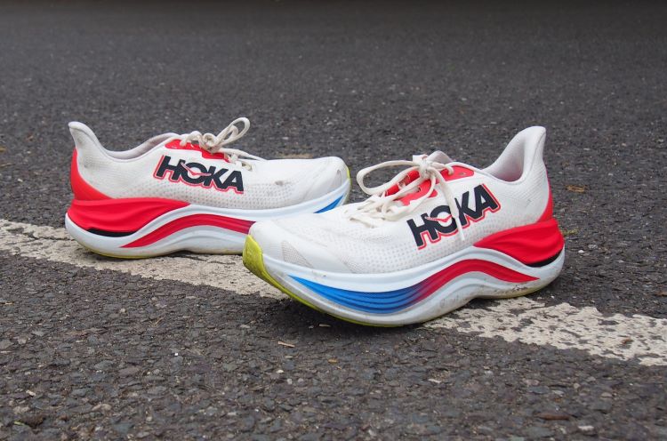 Pair of Hoka running shoes on tarmac