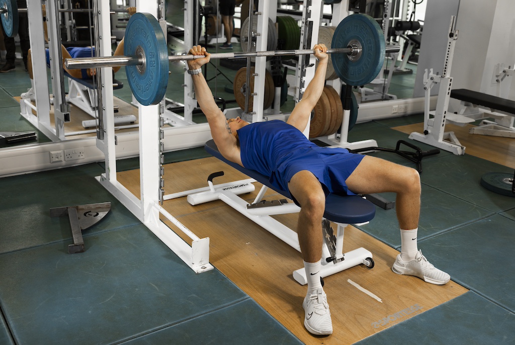 Olympic athlete Joe Clarke demonstrating a barbell bench press