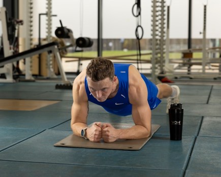 Olympian Joe Clarke demonstrating a plank exercise