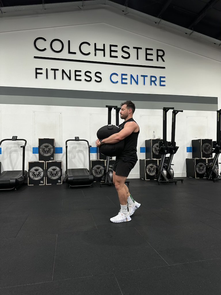 PT Harvey Lawton demonstrating how to do a sandbag carry