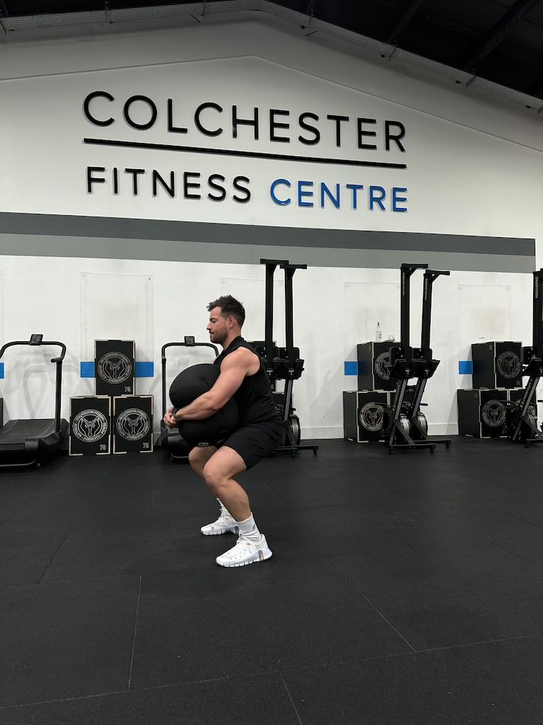 PT Harvey Lawton demonstrating how to do a sandbag squat