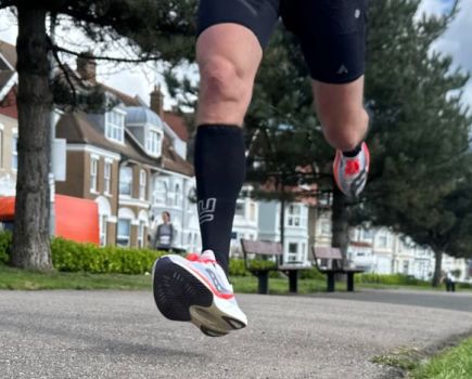 Close-up of a man's feet running in Saucony running shoes