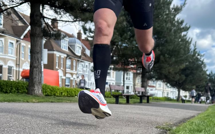 Close-up of a man's feet running in Saucony running shoes