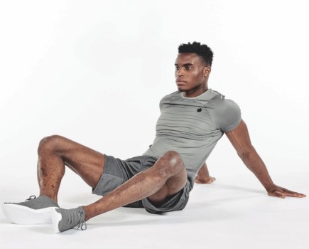 A man performing a butterfly yoga stretch