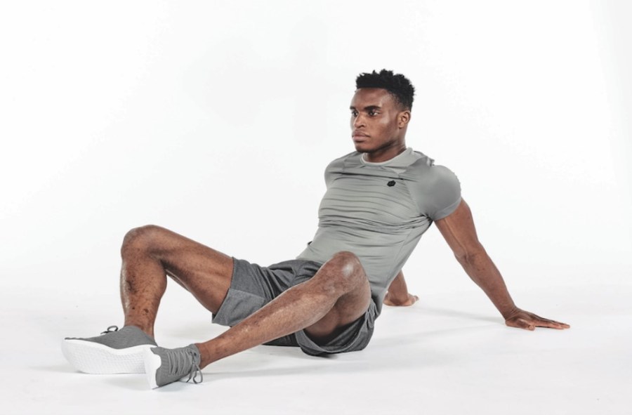 A man performing a butterfly yoga stretch