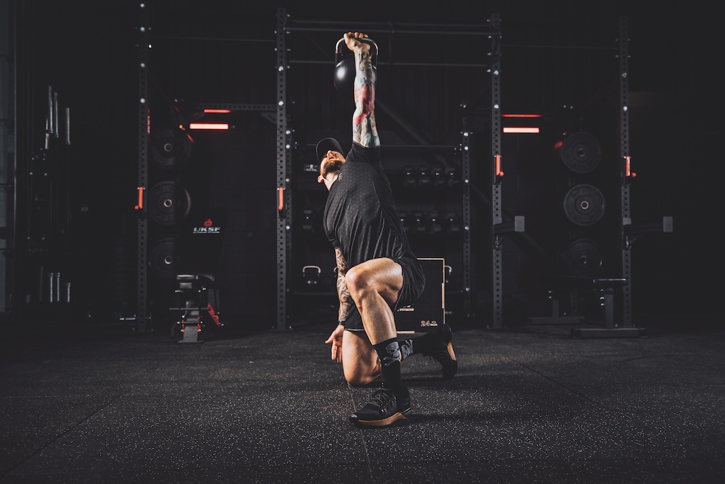 Anthony Stazicker demonstrating how to do a Turkish get-up as part of a functional strength workout