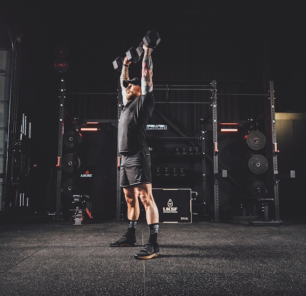 Anthony Stazicker demonstrating how to do a dumbbell man maker as part of a functional strength workout