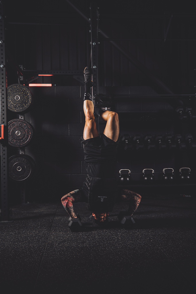 Anthony Stazicker demonstrating how to do a handstand push-up as part of a functional strength workout