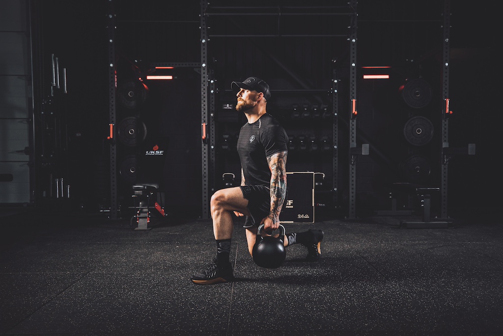 Anthony Stazicker demonstrating how to do a kettlebell lunge as part of a functional strength workout