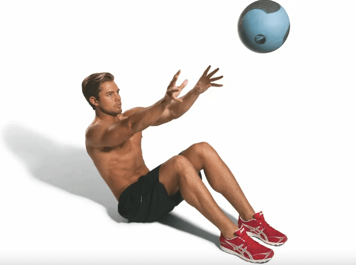 Man sitting and exercising with a gym ball