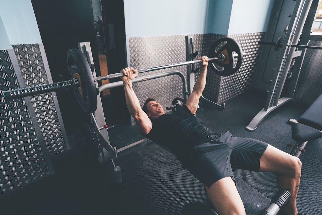 Swimmer Ben Proud performing bench press as part of a strength workout for swimmers