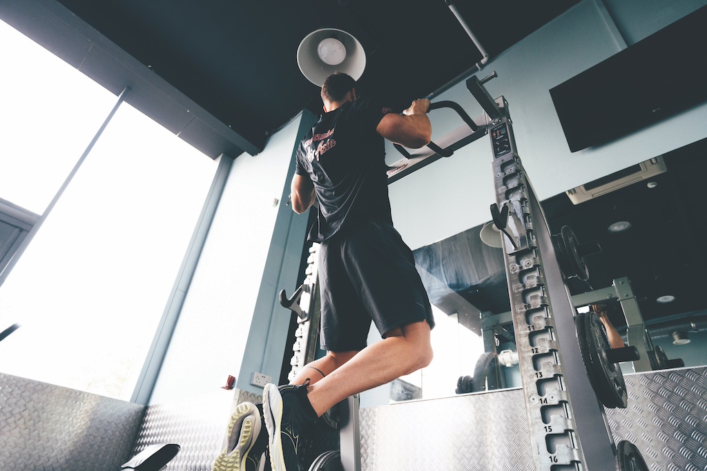 Swimmer Ben Proud performing a pull-up as part of a strength workout for swimmers