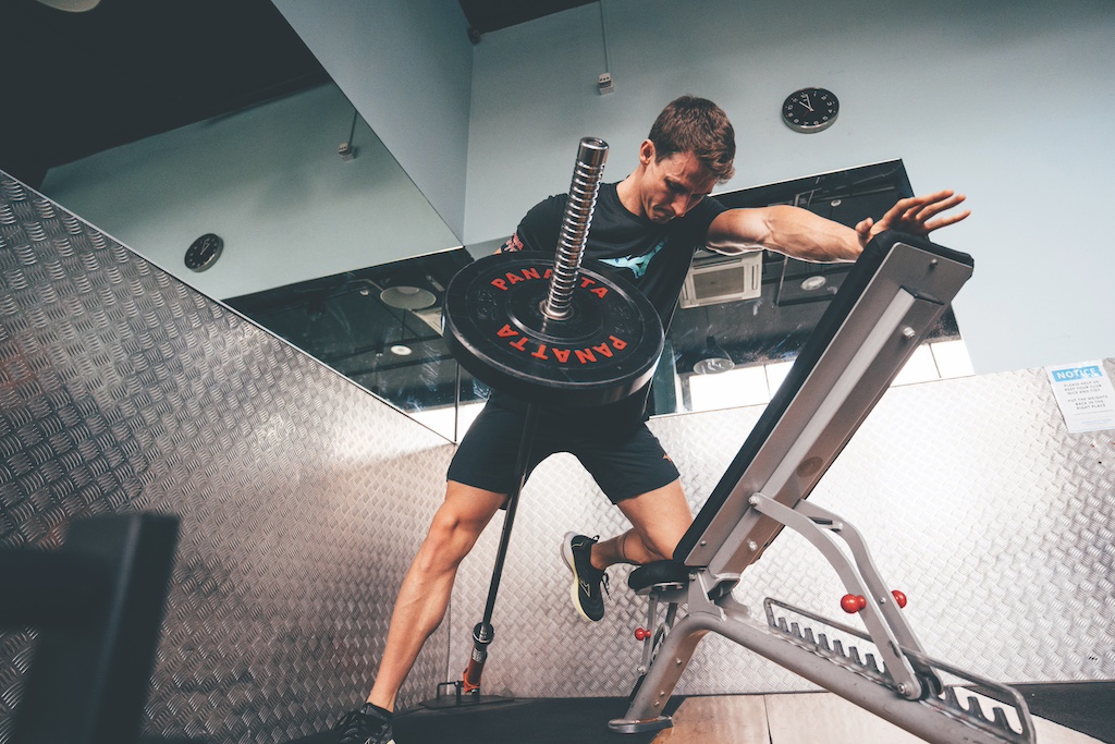 Swimmer Ben Proud performing a bench-support landmine row