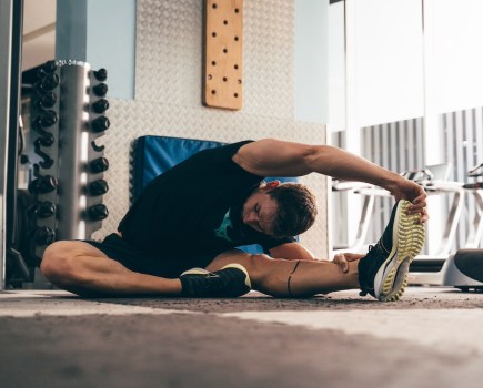 swimmer Ben Proud stretches in the gym