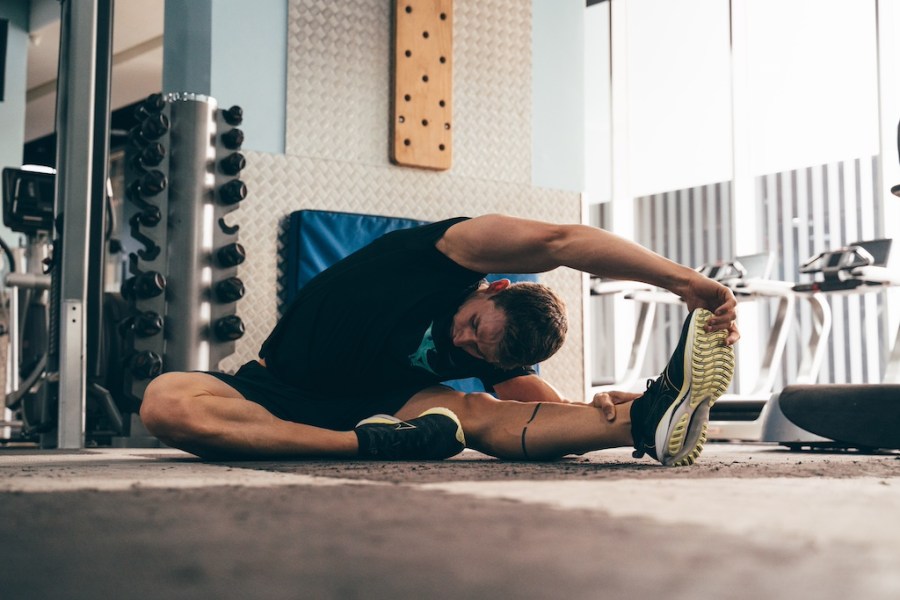 swimmer Ben Proud stretches in the gym