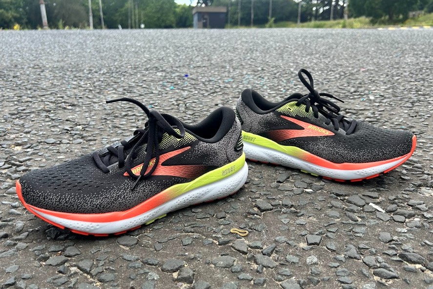 A pair of Brooks shoes on tarmac