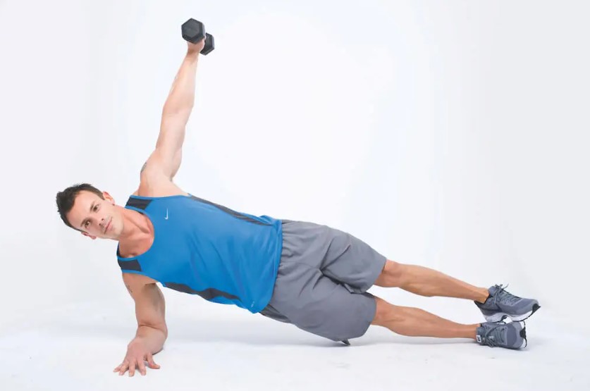 Man performing a dumbbell and gym ball abs workout