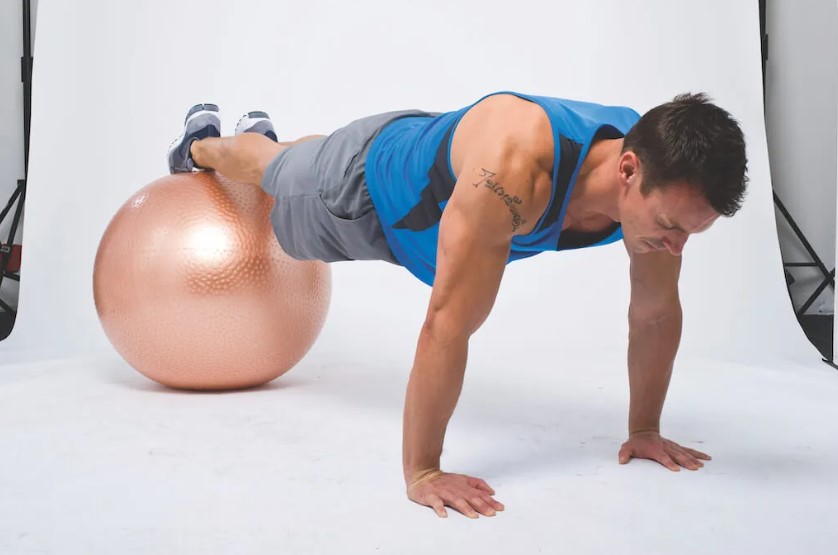 Man performing a dumbbell and gym ball abs workout