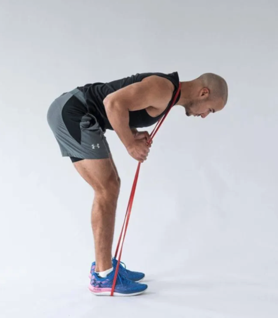 PT demonstrating a resistance band good morning exercise