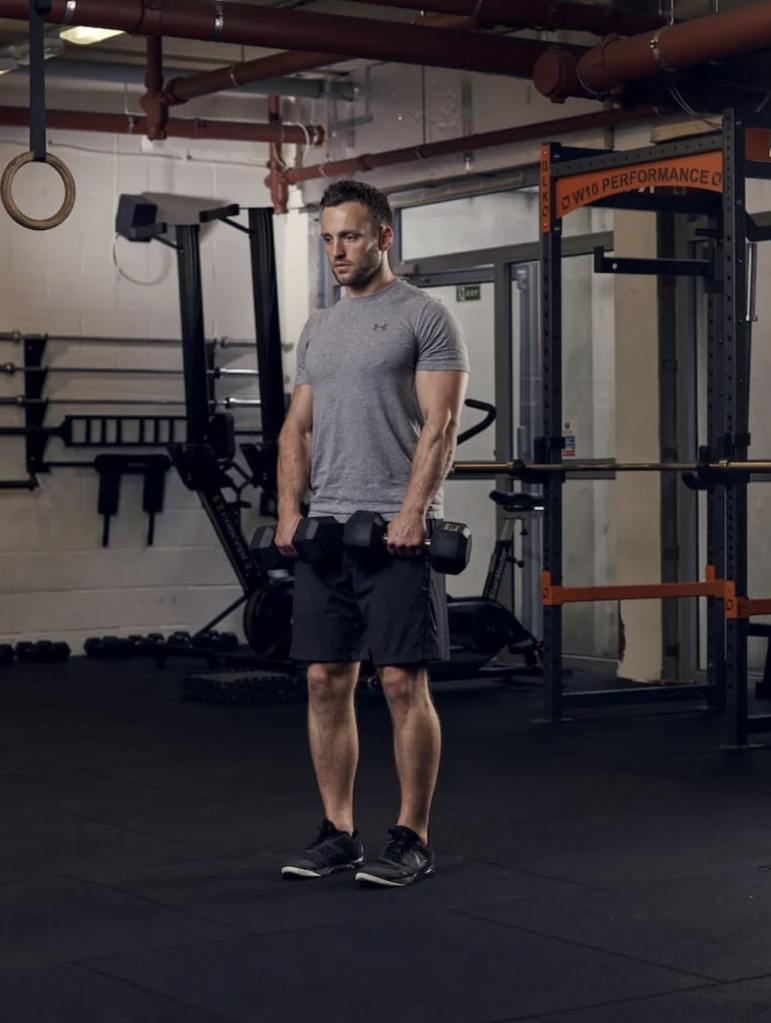 man performing dumbbell Romanian deadlift