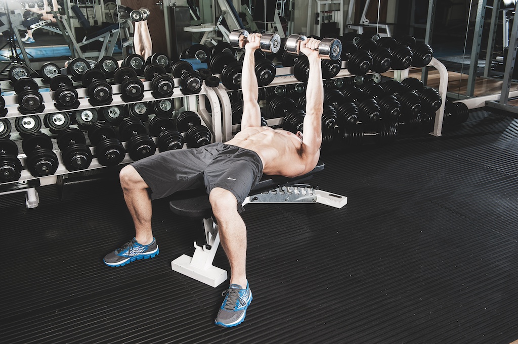 man doing dumbbell bench press