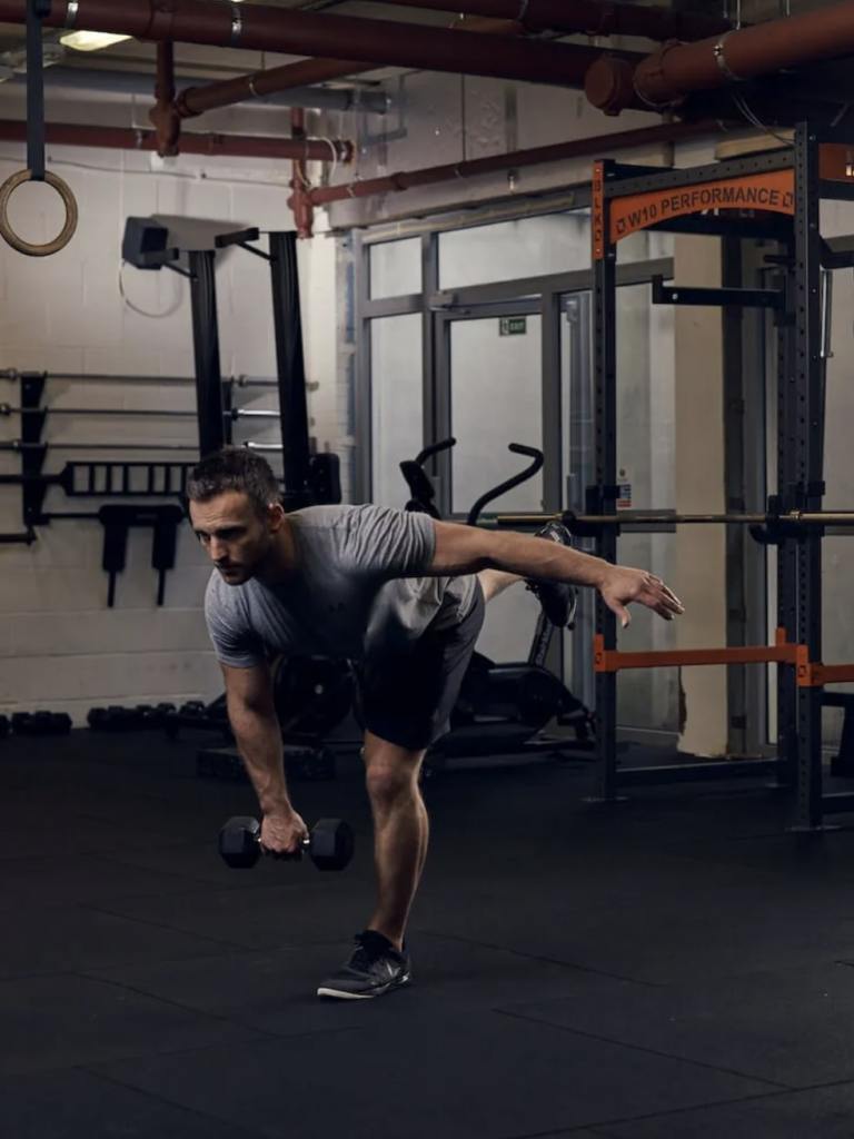 man performing dumbbell single-leg RDL