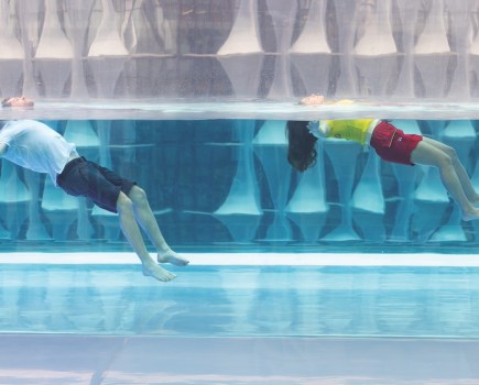 Float to Live campaign launch 2024 at Embassy Gardens Skypool, London in conjunction with Helly Hansen. RNLI lifeguards Courtney Randino and Dominik Fajkiel demonstrated the Float to Live technique in the floating swimming pool, and case study Michael Whiteley talked about using the technique which saved his life